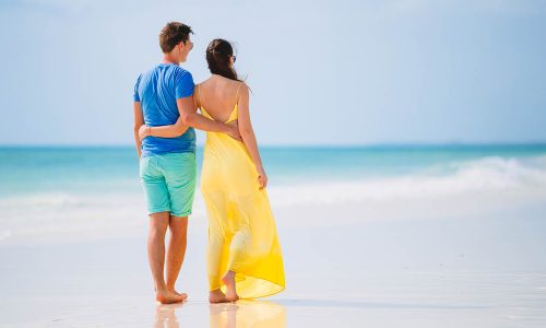 Young family on white beach during summer vacation